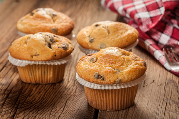 Tasty muffins on wooden boards