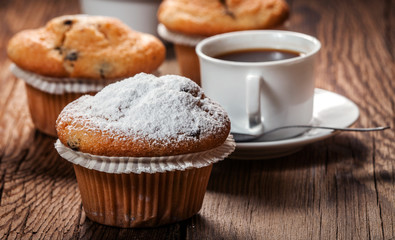 Tasty muffins on wooden boards