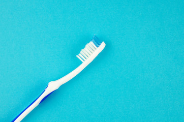 Toothbrushes on blue background. Copy space for text