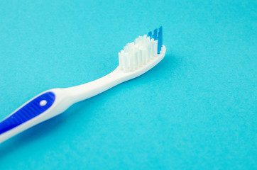 Toothbrushes on blue background. Copy space for text