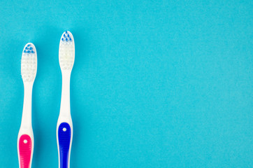 Toothbrushes on blue background. Copy space for text