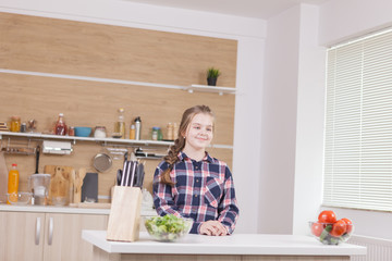 Beautiful little girl smiling while cooking. Food preparing.