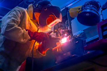Welder. The man does the work. A man at work. Welding work. Welder costume. Working. Welding mask. Welding electrodes.
