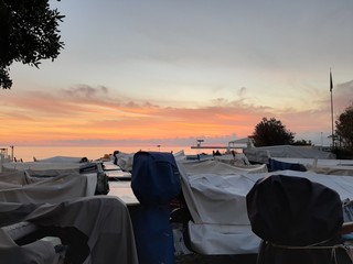 An amazing caption of  small waves and  beautiful  sunset with an incredible reflection over the sea and some coloured clouds in winter days