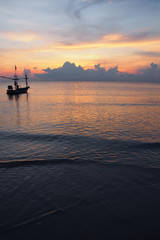 Sunrise, the colors of the morning sky with a fishing boat.