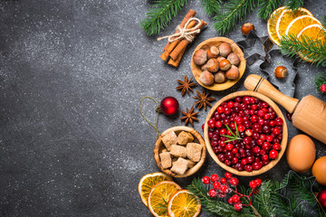 Christmas food baking background top view on black background.