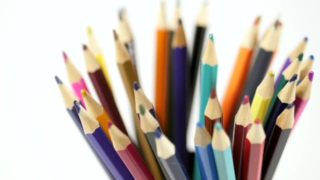 Pencil on a white background. Camera in motion. Pencils are in the glass