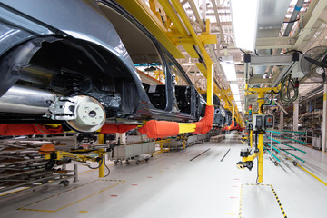 transfer of car body bottom view. Robotic equipment makes the Assembly of car. Modern car Assembly...