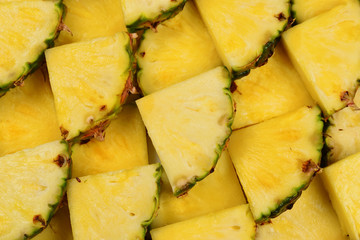 Pineapple juicy yellow slices background. Top view.