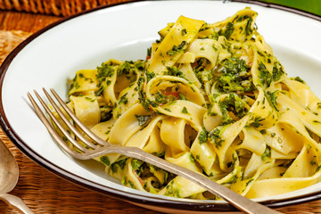 Spaghetti with spinach and bacon.