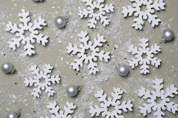 White Snowflakes on Beige Background, Top View