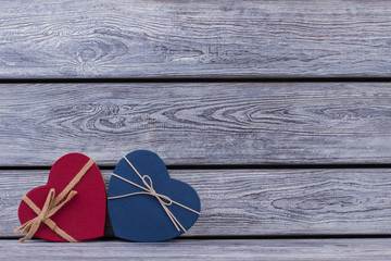 Red and blue heart-shaped goft boxes. Valentines Day background with colored boxes in a shape of heart. Romantic holiday greeting card.