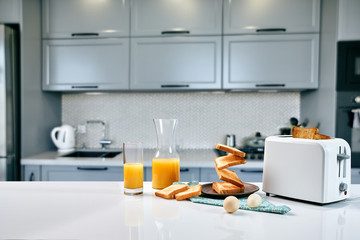 Flying toasts for breakfast and a glass of orange juice drink. Levitation food and healthy breakfast concept.