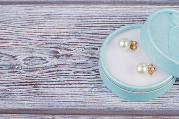 Floral fashion pearl earrings. Gift box with pearl earrings and copy space. Luxury packaging gift...