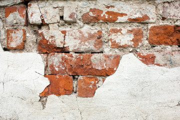 textured background old cracked red brick wall with crumbling white paint
