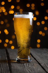 lager draft beer in a glass on dark wooden table