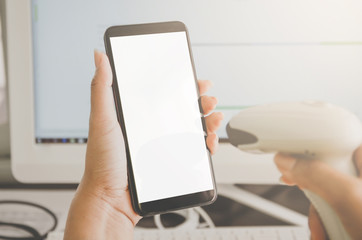 Concept of shopping and human hands are holding smartphone with barcode reader.