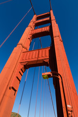 Golden Gate Bridge, San Francisco, California, tower against a bright blue sky looking up