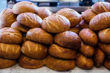 Fresh sourdough bread stacked in a bakery ready to sell and eat