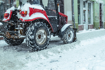 snowstorm in city. cleaning streets of snow