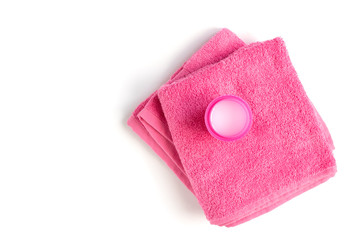 Laundry detergent liquid gel and pink towel isolated on white background.