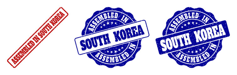 ASSEMBLED IN SOUTH KOREA grunge stamp seals in red and blue colors. Vector ASSEMBLED IN SOUTH KOREA marks with grunge surface. Graphic elements are rounded rectangles, rosettes,