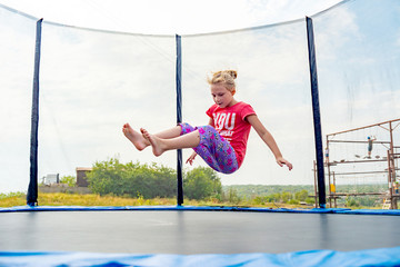 The girl falls on a rubber trampoline.