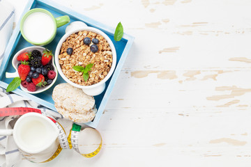 Healthy breakfast set with muesli, berries and milk