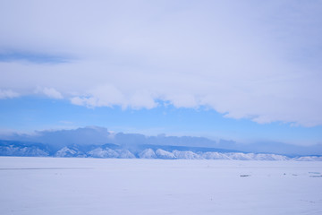 Blue mountains of lake Baikal in Siberia, in cloudy