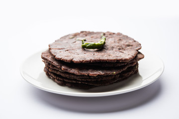 Ragi roti or flat Bread made using finger millet is a healthy and tasty breakfast dish of Karnataka, India. served with green chilli and chutney. selective focus