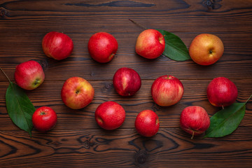 flat lay of ripe red apples on wooden table, autumn concept