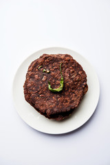 Ragi roti or flat Bread made using finger millet is a healthy and tasty breakfast dish of Karnataka, India. served with green chilli and chutney. selective focus