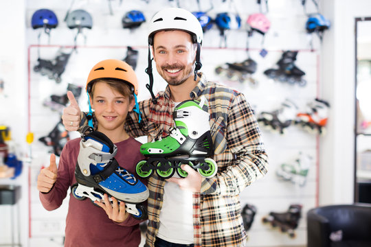 Adult father and son boasting roller-skates