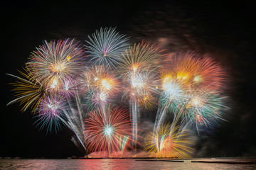 Fantastic Multicolor Firework exploding for Celebration from the big boat over the sea, celebration and happy new year and merry christmas concept