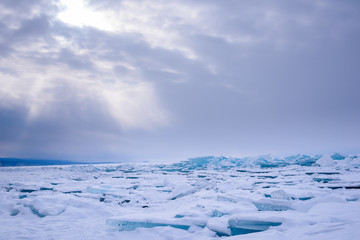 Fototapeta na wymiar Transparent Ice Lake Baikal similar to broken glass