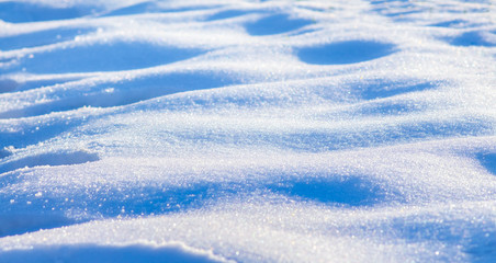 Fototapeta na wymiar The texture of snow on a clear sunny winter day_
