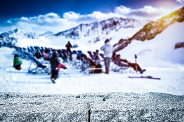 Stone table in the mountains among skiers  