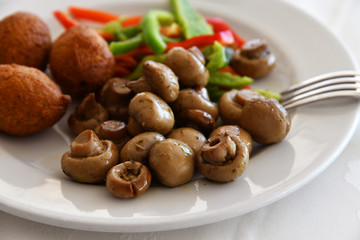 Fried mushrooms and a vegetables on plate