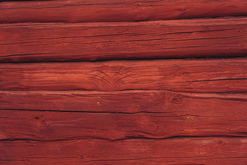 Wooden red log wall background, traditional in Scandinavia
