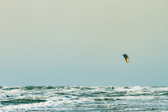Kitesurfing at the seaside with big waves