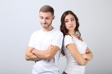 Fototapeta premium Young couple in white t-shirts on grey background