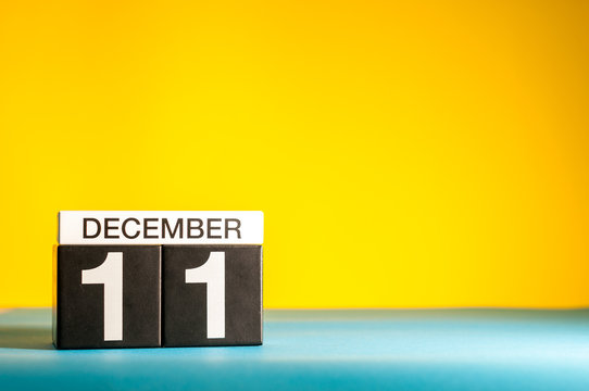 December 11th. Image 11 day of december month, calendar on yellow background with empty space for text
