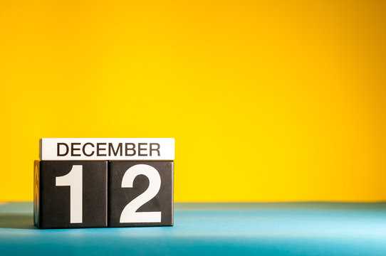 December 12th. Image 12 day of december month, calendar on yellow background with empty space for text
