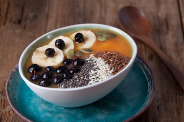 Pumpkin smoothies with banana and blueberries and  seeds