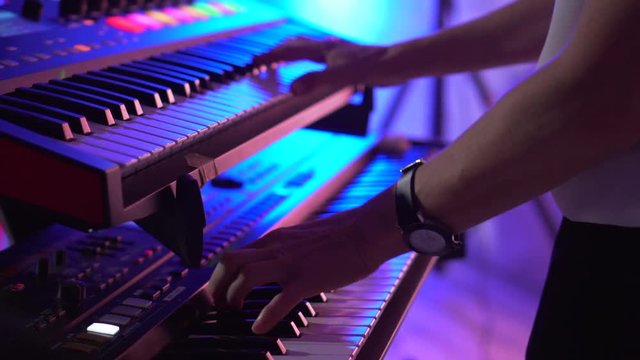 keyboard player playing synthesizer close-up