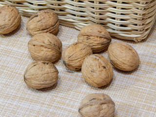 Walnuts in a basket on a brown background