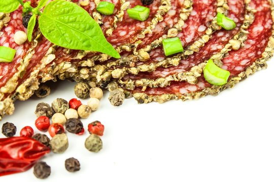 Dried Organic Salami Sausage Covered With Pepper On White Background. Italian Dried Salami Crusted In Ground Black Pepper.