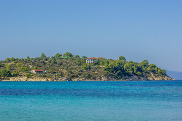 Naklejka premium Aegean sea bay waterfront shore tropic landscape with view to island, summer tourist vacation holidays landscape, copy space