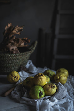 Guava and autumn leaves on table