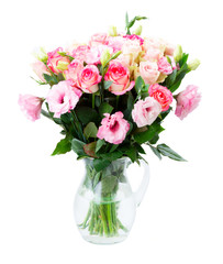 Rose and eustoma fresh pink flowers bouquet in glass vase isolated on white background